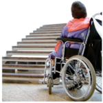 Person in a wheelchair facing a long flight of stairs.