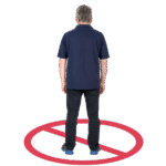 Person standing with back to viewer inside a red no entry symbol.