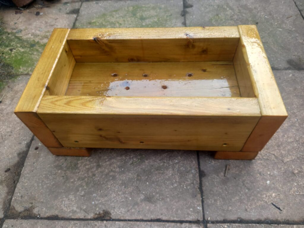 Planter (bespoke sizes and different colours available). It has drainage holes at the bottom to allow rain water to escape.