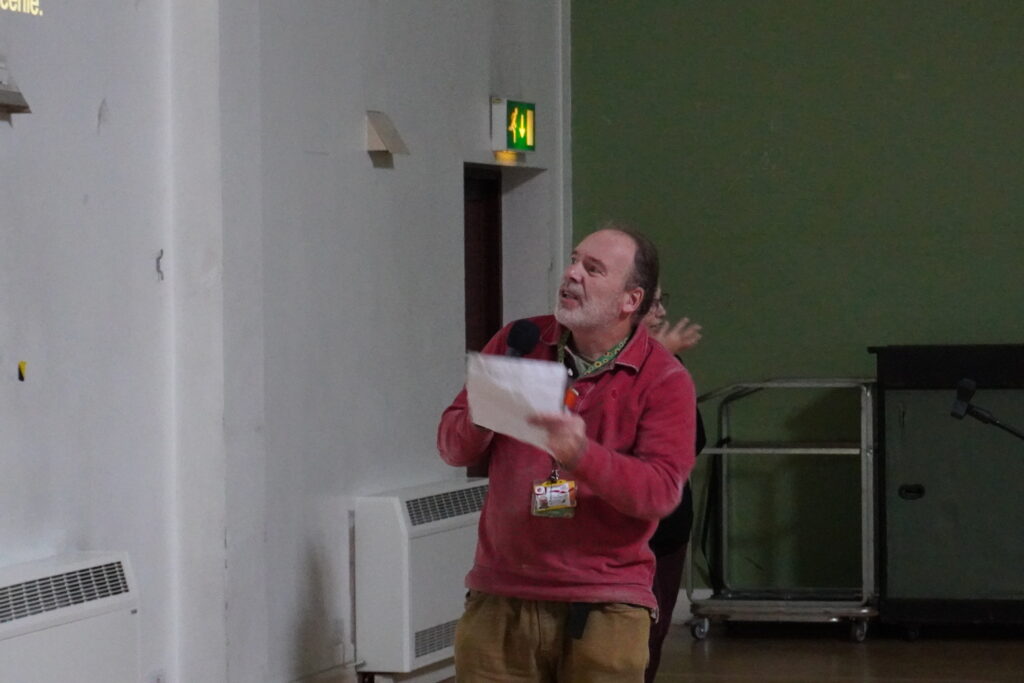 Duncan looking at the screen and describing photos from his allotment