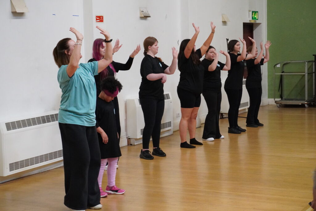 Abbott Movement performing with their hands in the air