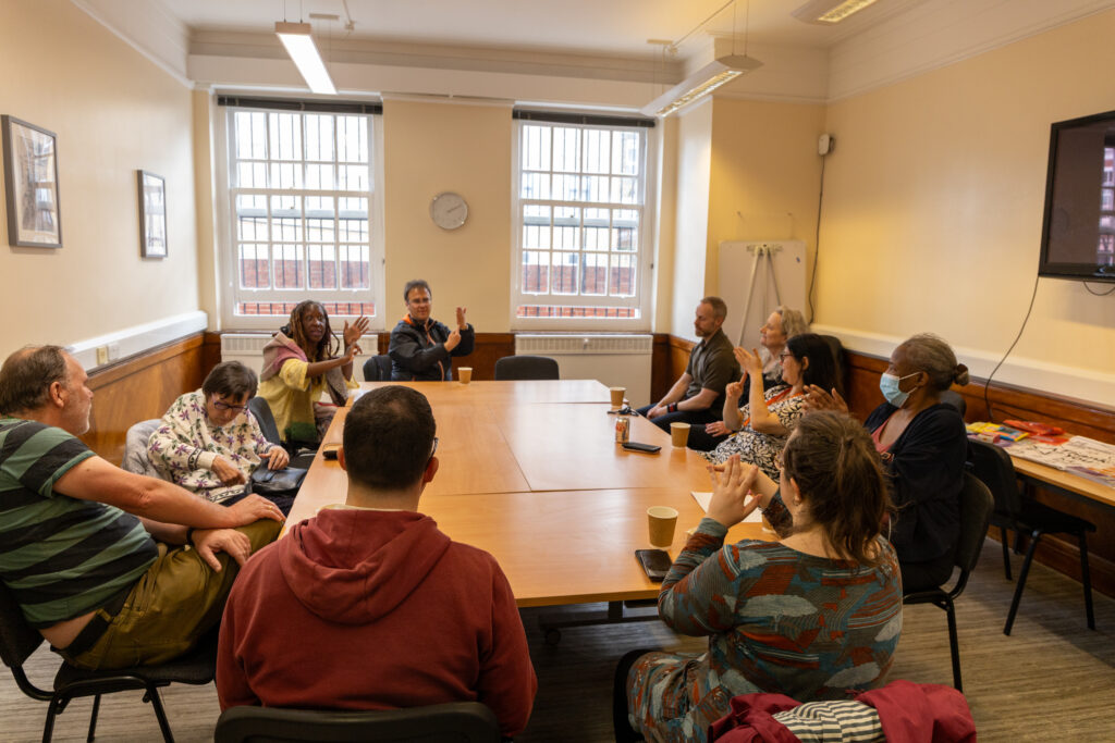Group of people around a table at Coffee and Chat